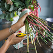 © cherry_d - Florist at work: pretty young blond woman making fashion modern bouquet of different flowers