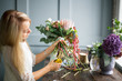 © cherry_d - Florist at work: pretty young blond woman making fashion modern bouquet of different flowers