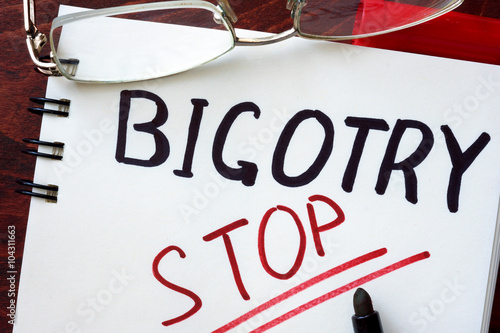 Fotografia, Obraz Stop Bigotry concept written in a notebook on a wooden table.