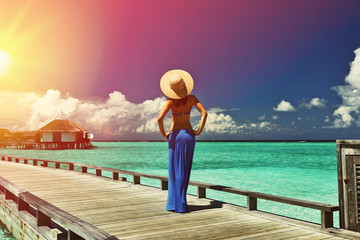 Poster - Woman on a beach jetty at Maldives