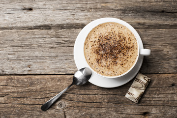 Close-up of coffee cup  on wooden background.