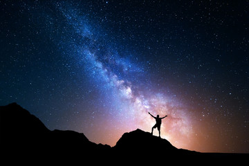 Wall Mural - milky way. night sky and silhouette of a standing man