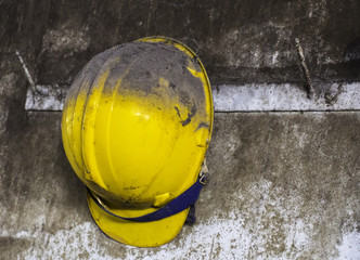 yellow construction helmet hanging on shelf