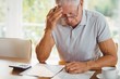 Worried senior man with tax documents