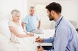 © WavebreakMediaMicro - Handsome nurse visiting a mature woman