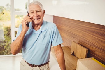 Wall Mural - Smiling senior man on a phone call