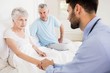 © WavebreakmediaMicro - Handsome nurse holding hand of mature woman