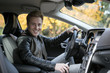 © Westend61 - Portrait of smiling young man in car