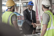 © Westend61 - Construction worker and executive shaking hands in construction site