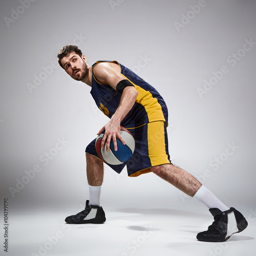 Full length portrait of a basketball player with ball Poster