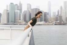 USA, New York City, Young Woman Standing On An Excursion Boat In Front Of The Skyline