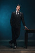 © ysbrandcosijn - Retro 1940s business man in suit and tie standing next to empty