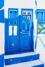 Traditional Greek Stone House, Blue Gate And Window Shutters, Santorini Island, Greece.