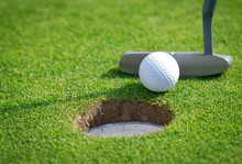 Close-up Of Golf Hole With Putter And Ball