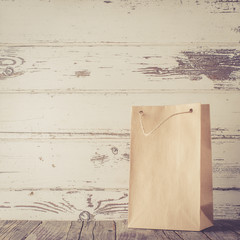 Poster - Paper gift bag on wooden table