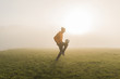 © Westend61 - Young man playing soccer on meadow in the evening