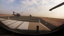 A Squadron Of Helicopters Fly In Formation Over Afghanistan.