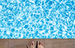 male feet standing at swimming pool