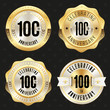Collection of gold  100th anniversary badges on black background