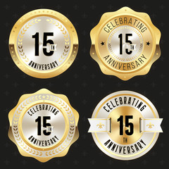 Collection of gold  15th anniversary badges on black background