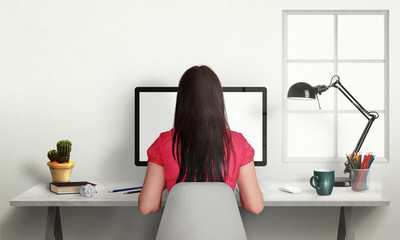 Aufkleber - Woman work on office computer with isolated screen for mockup. Modern office interior with window, lamp, plant, coffee, pencils.