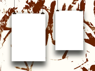 Close-up of two hanged paper sheets with clips on brown ink splotchy background