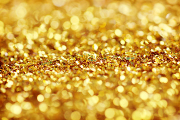 Shiny dark golden glitter lights background