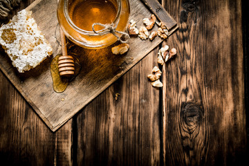 Wall Mural - Sweet honey in the comb, glass jar with nuts.