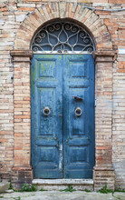 Blue Wooden Door With Arch In Old Brick Wall