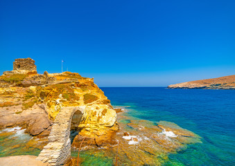 Wall Mural - beautiful old bridge made of stone in the sea at Chora, the capital of Andros island in Greece