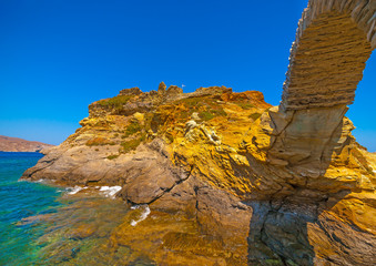 Wall Mural - beautiful old bridge made of stone in the sea at Chora, the capital of Andros island in Greece