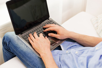 Sticker - close up of man typing on laptop computer at home