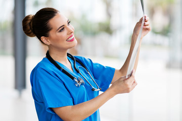 Wall Mural - young medical doctor looking at x-ray film