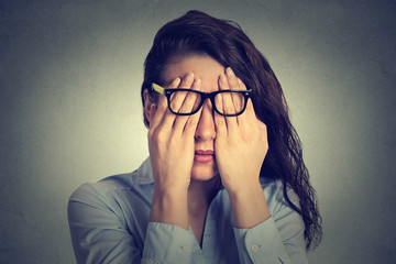 portrait young woman in glasses covering face eyes using her both hands