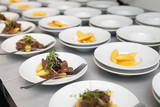 Fototapeta  - preparation of buffet plates with beef and Schupfnudel dishes