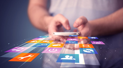 Poster - Man holding smart phone with colorful application icons