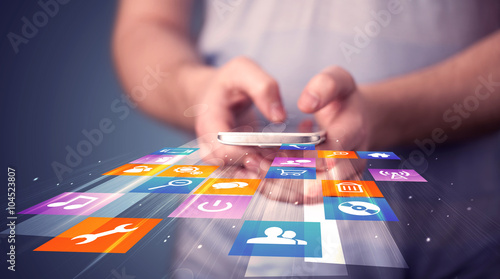 Fotografía Man holding smart phone with colorful application icons