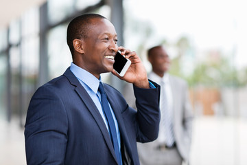 Wall Mural - black businessman talking on cell phone