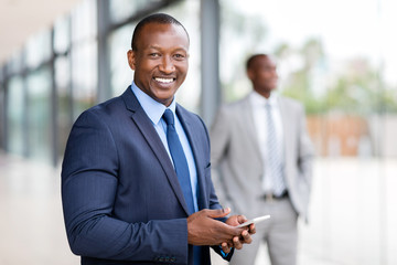 Wall Mural - african american businessman using cell phone