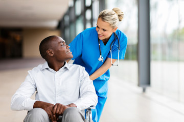 female nurse talking to disabled patient
