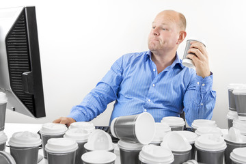 Wall Mural - Hardworking business man drinks too much coffee