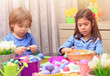 © Anna Om - Brother and sister coloring Easter eggs