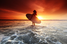 Surfer Woman On Beach At Sunset