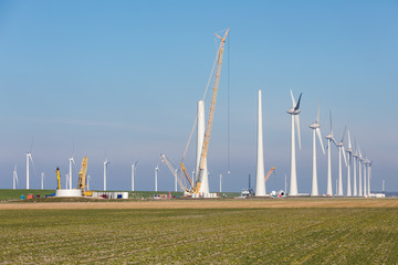 Construction site of new big Dutch wind farm in agricultural landscape