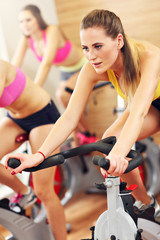 Poster - Sporty women on spinning class