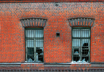 Old broken window on red brick wall