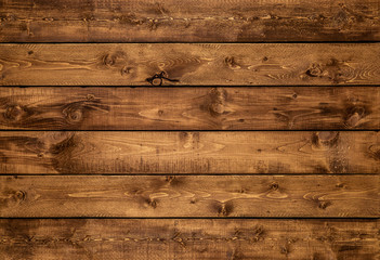 medium brown wood texture background viewed from above. the wooden planks are stacked horizontally a