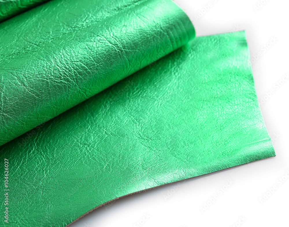 Green leather texture on white background, close up