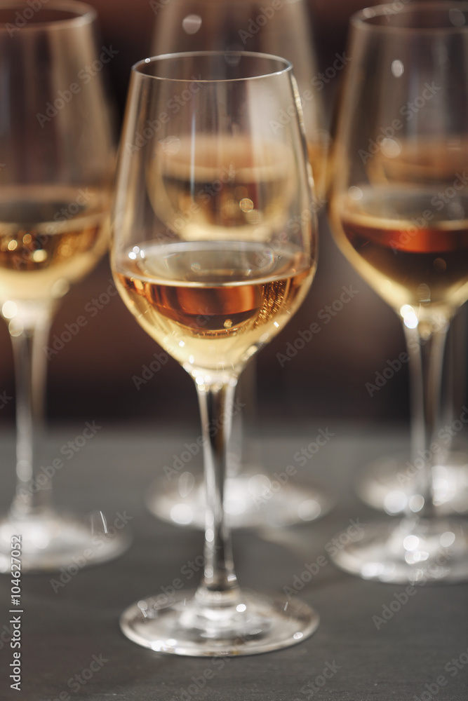 Glasses with white wine on blurred background