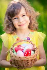 Wall Mural - Child holding basket with Easter eggs